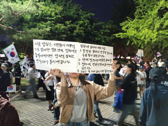 손피켓을 든 시민 (사진 : X 사용자 '츄르주세요')